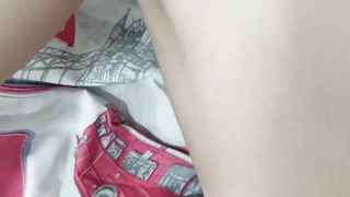 Solo performer with a toy on rumpled bedsheets