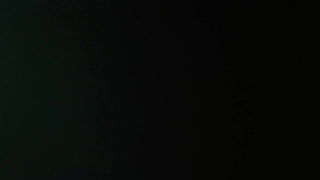 Explicit massage scene in a softly lit room