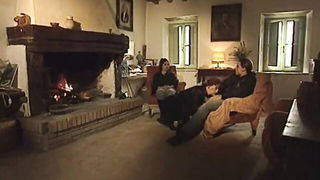 Couple on a made bed in an explicit scene