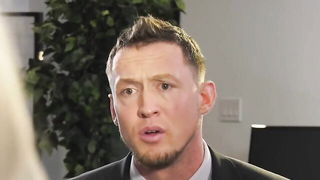 Couple on a patterned bedspread in an explicit scene