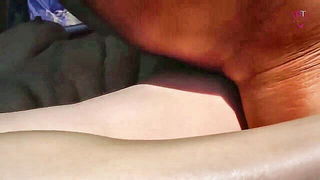 Couple on a made bed in an explicit scene