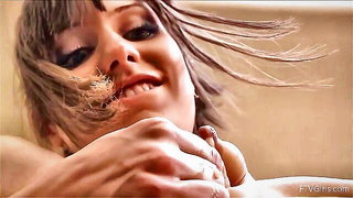 Amateur couple on a living room sofa in explicit scene