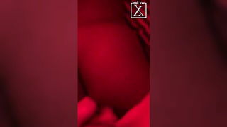 Couple on a made bed in an explicit scene