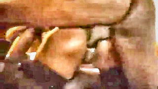 Couple mid-scene in a dim bedroom