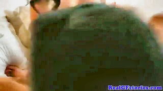 Explicit massage scene in a softly lit room