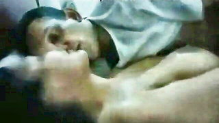 Couple on a patterned bedspread in an explicit scene