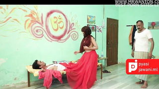 Couple on a patterned bedspread in an explicit scene