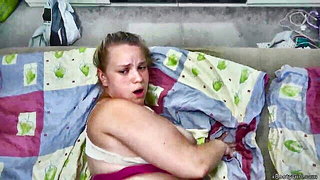 Couple on a made bed in an explicit scene