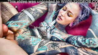 Solo performer with a toy on rumpled bedsheets