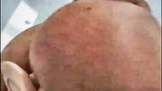 Explicit doggy style scene on a wide bed