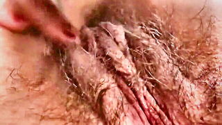 Explicit massage scene in a softly lit room