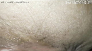 Amateur couple on a living room sofa in explicit scene