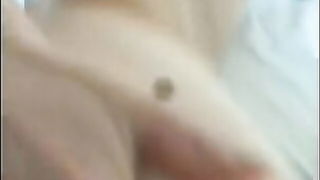 Explicit massage scene in a softly lit room