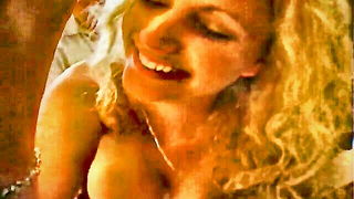 Solo performer with a toy on rumpled bedsheets