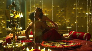 Pair of performers in motion on a wide bed