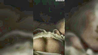 Couple on a patterned bedspread in an explicit scene