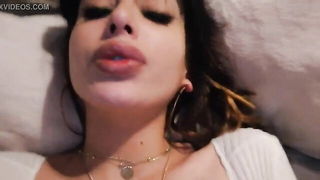 Amateur couple on a living room sofa in explicit scene