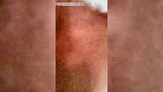 Couple on a made bed in an explicit scene