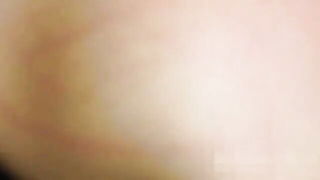 Amateur couple on a living room sofa in explicit scene