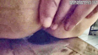 Couple on a made bed in an explicit scene