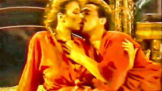 Studio set with performers in an explicit scene under bright lights