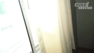 Couple on a made bed in an explicit scene