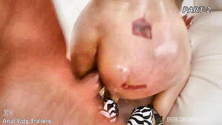 Amateur couple on a living room sofa in explicit scene