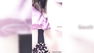 Solo performer with a toy on rumpled bedsheets
