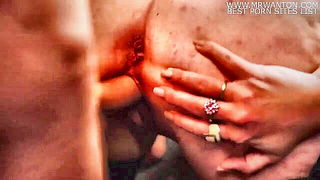Explicit massage scene in a softly lit room