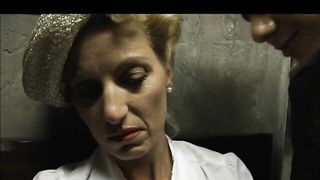 Solo performer with a toy on rumpled bedsheets