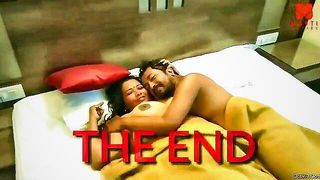 Couple mid-scene in a dim bedroom