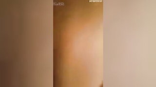 Solo performer with a toy on rumpled bedsheets