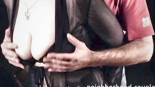 Couple on a made bed in an explicit scene