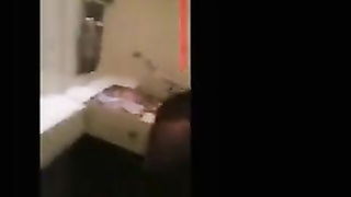 Explicit massage scene in a softly lit room