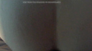Amateur couple on a living room sofa in explicit scene