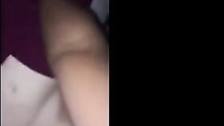 Amateur couple on a living room sofa in explicit scene