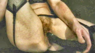 Explicit massage scene in a softly lit room
