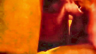 Amateur couple on a living room sofa in explicit scene