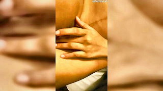 Amateur couple on a living room sofa in explicit scene