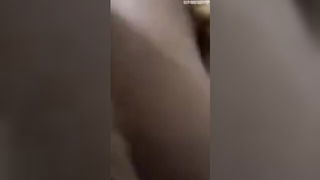 Amateur couple on a living room sofa in explicit scene