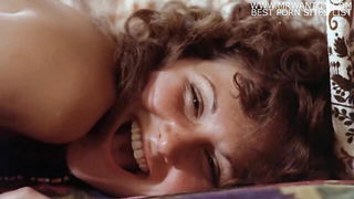 Solo performer with a toy on rumpled bedsheets