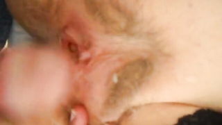 Couple on a made bed in an explicit scene