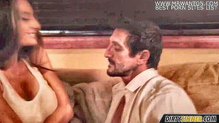 Couple on a patterned bedspread in an explicit scene
