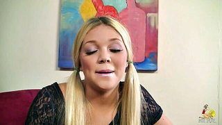 Solo performer with a toy on rumpled bedsheets