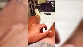 Solo performer with a toy on rumpled bedsheets