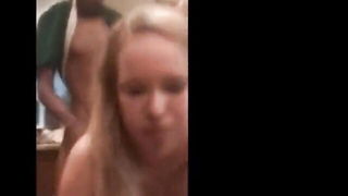 Amateur couple on a living room sofa in explicit scene