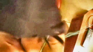 Amateur couple on a living room sofa in explicit scene