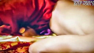 Explicit massage scene in a softly lit room