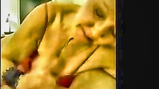 Amateur couple on a living room sofa in explicit scene