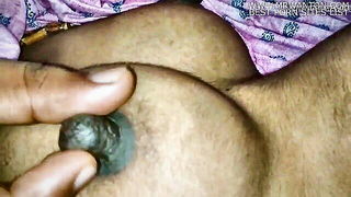 Amateur couple on a living room sofa in explicit scene